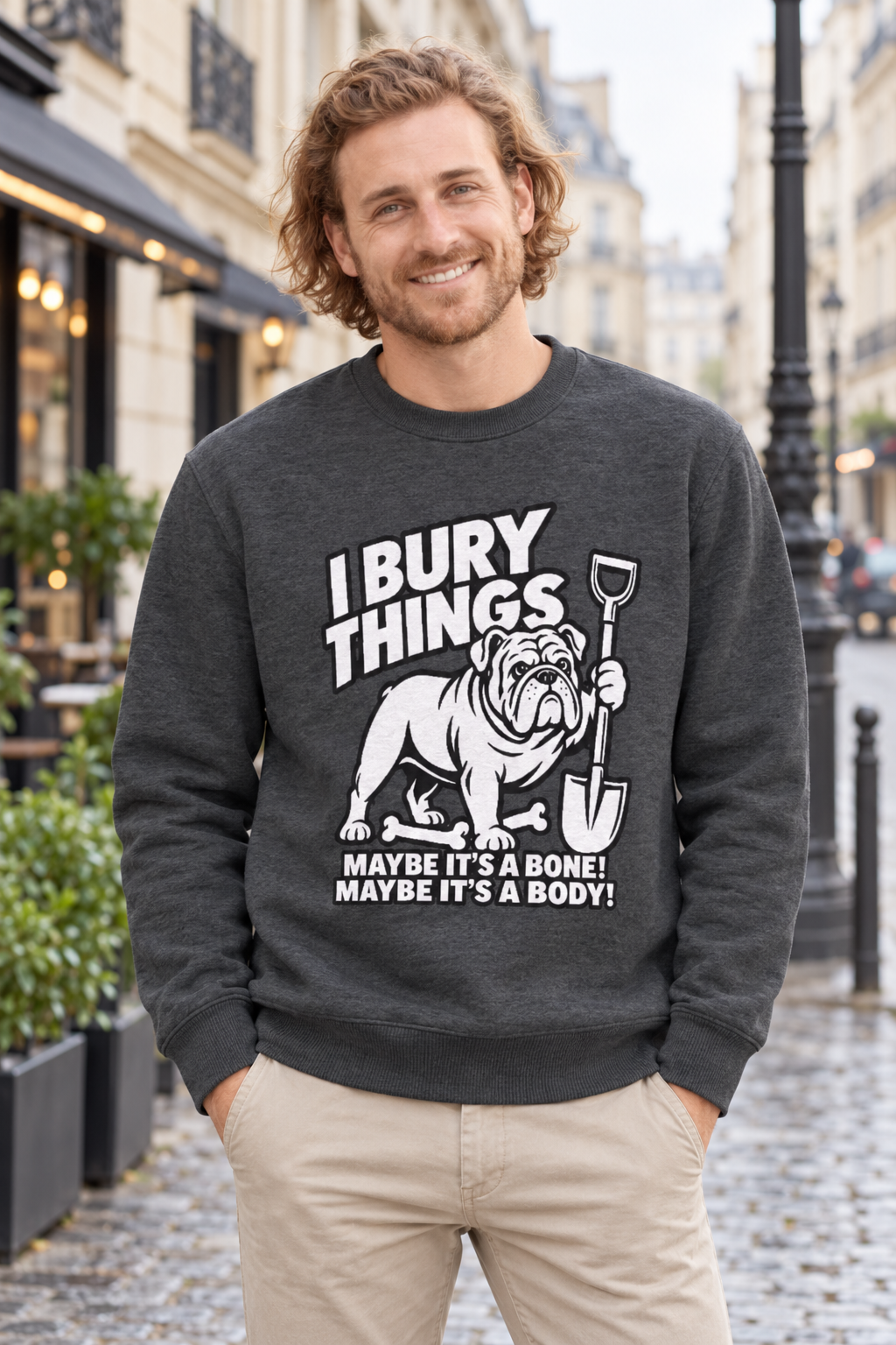 Man wearing the charcoal I Bury Things bulldog jumper on a European city street