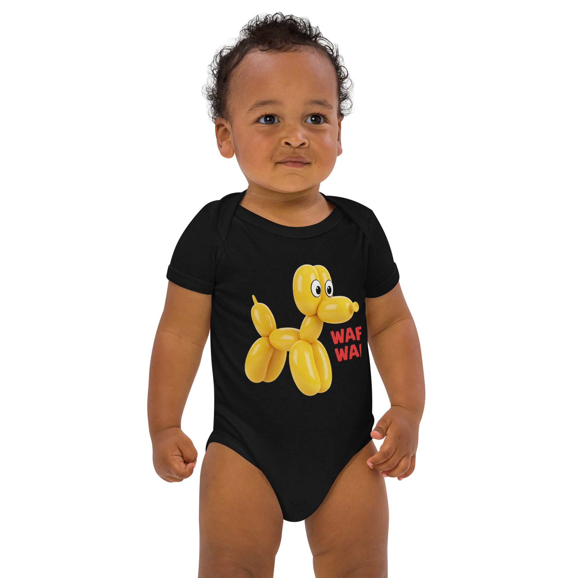 Baby wearing a black short-sleeve bodysuit featuring a yellow balloon dog graphic and playful text, shown on a white background.